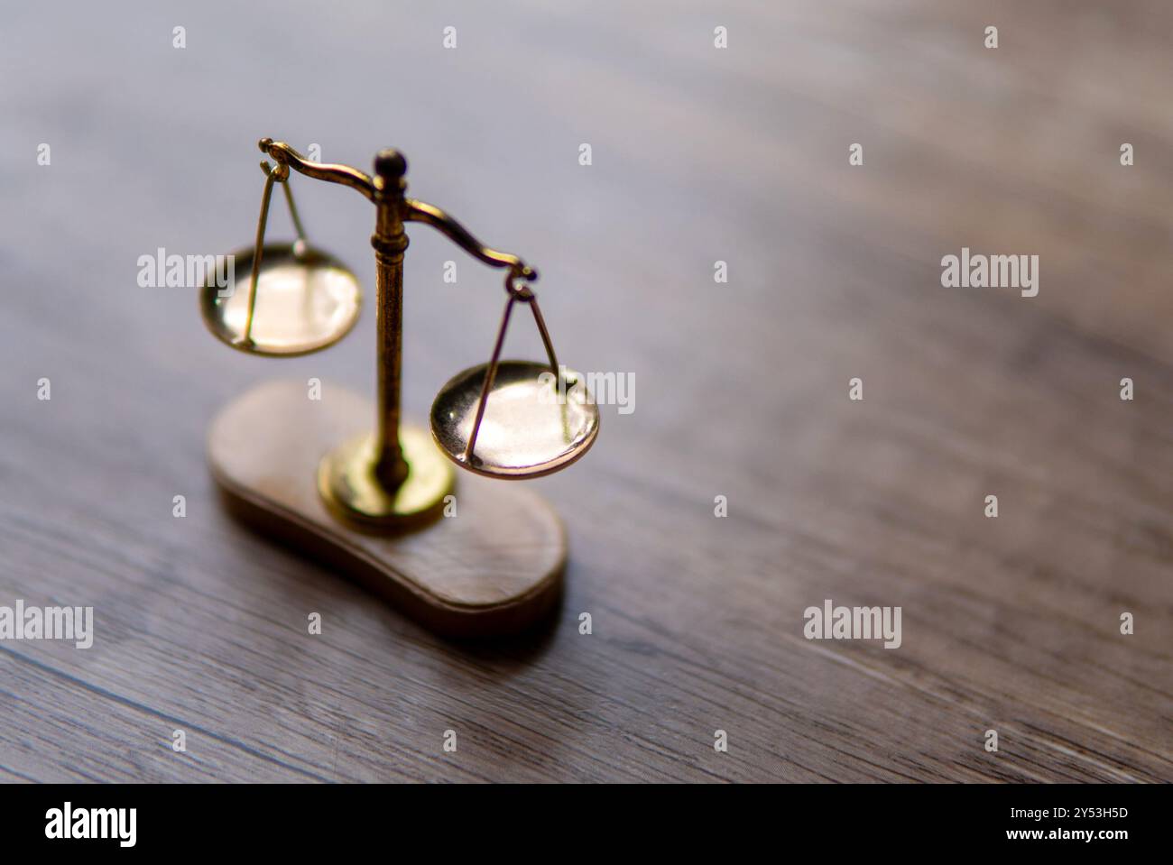 Eine Nahaufnahme einer Waage mit zwei ausbalancierten Platten auf einem Holztisch. Kopierbereich für Text. Balance, Gerechtigkeit und Fairness Konzept. Stockfoto