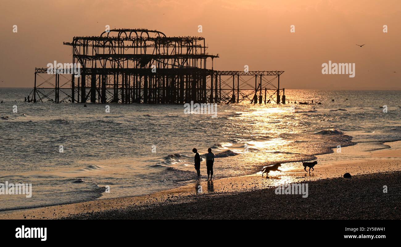 Brighton , Großbritannien 20. September 2024 - die Sonne geht heute Abend hinter dem West Pier in Brighton nach einem weiteren warmen, sonnigen Tag an der Südküste unter: Credit Simon Dack / Alamy Live News Stockfoto