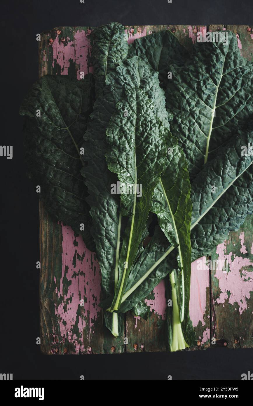 Cavolo nero Schwarzes Grünkohl-Gemüse auf altem Holzbrett Stockfoto