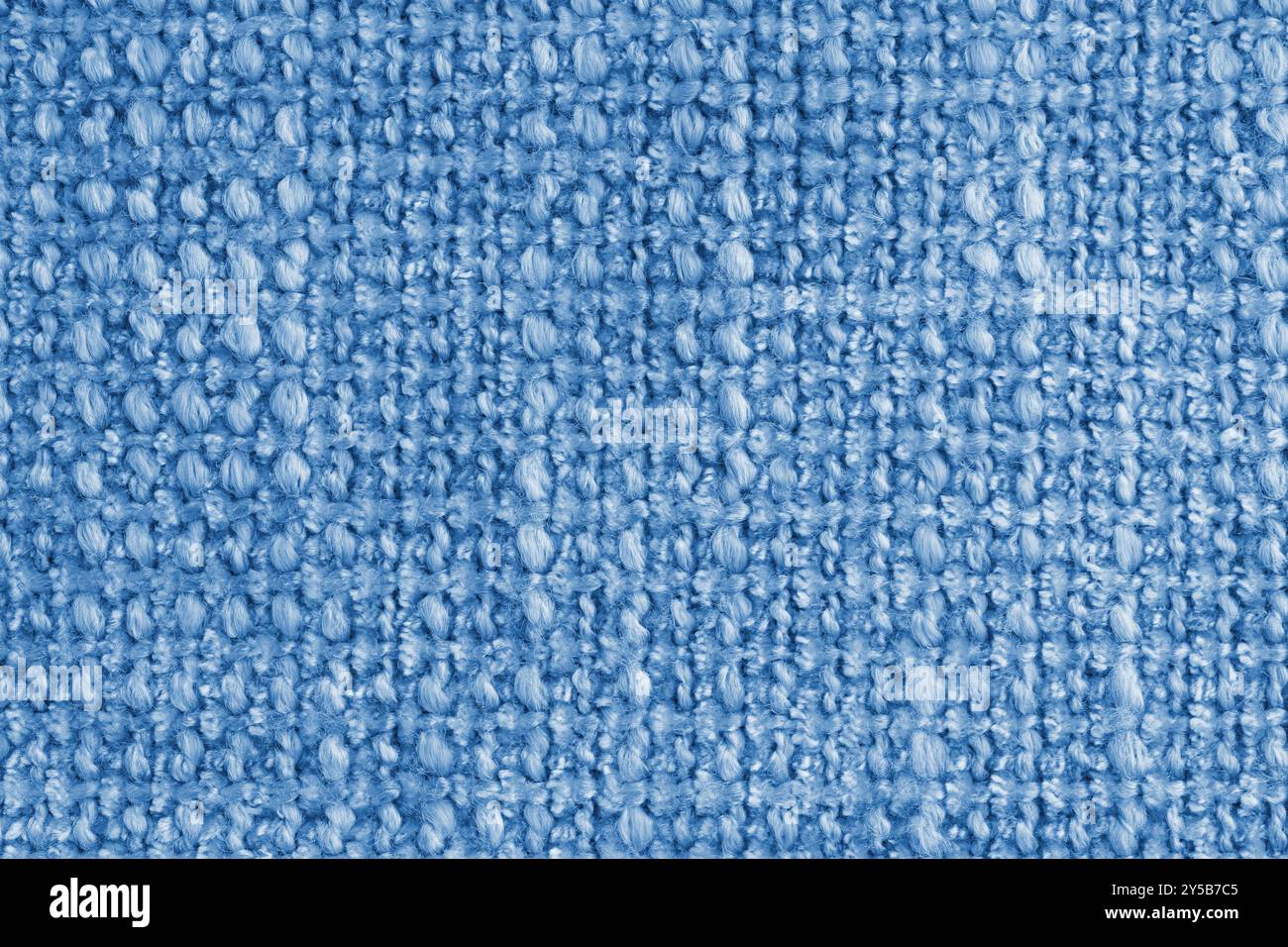 Textur des blauen Jacquard-Gewebes aus rauem Gewebe, Stoffstrukturhintergrund, Nahaufnahme, Makro. Material für Heimtextilien, Polster und Vorhangdekor, Stockfoto