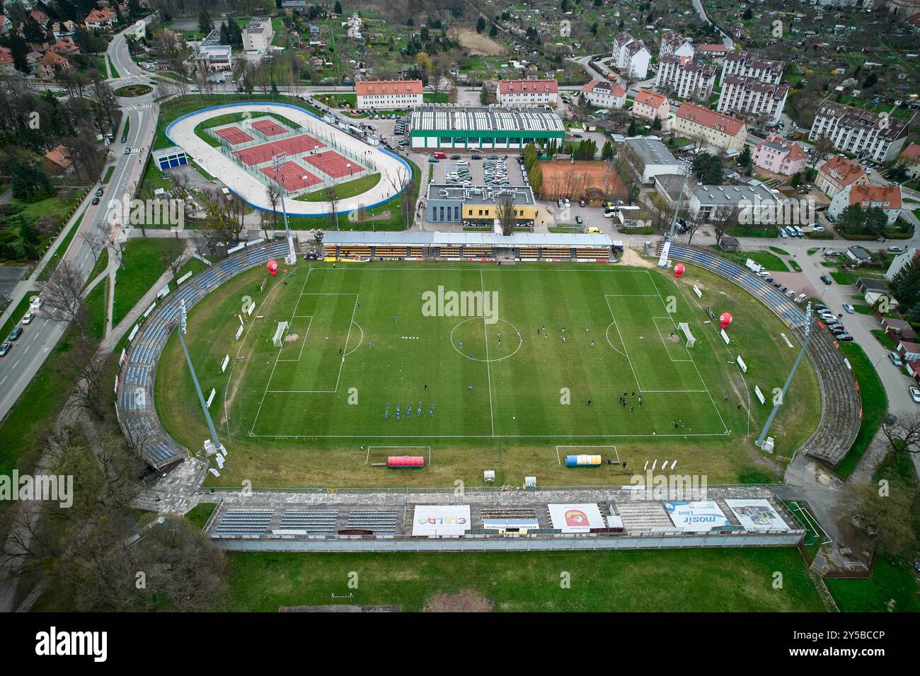 Blick aus der Vogelperspektive auf das Stadtstadion von Elbląg, umgeben von Wohngebäuden und Grünflächen an einem bewölkten Tag Stockfoto