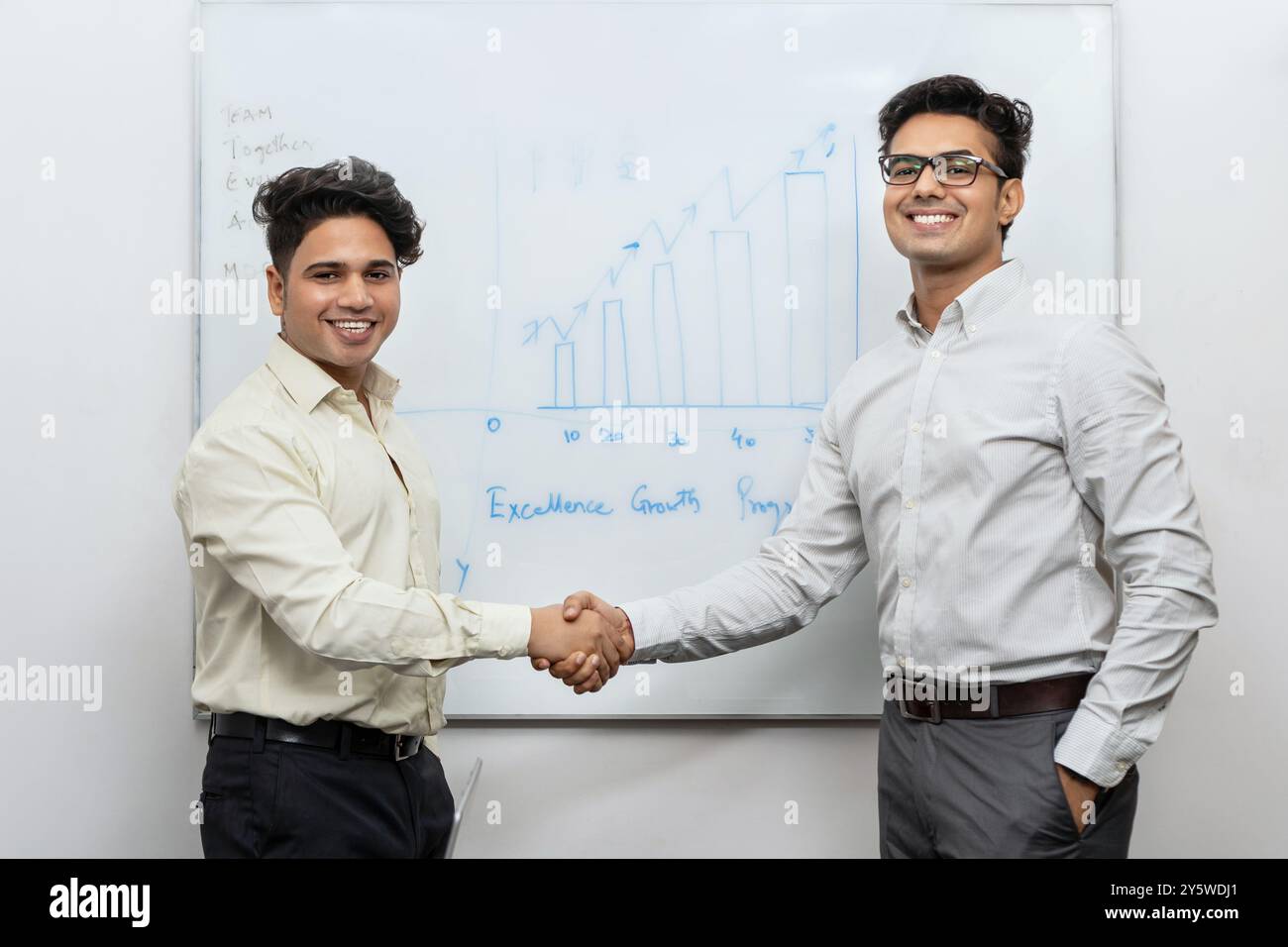 Ein Vorgesetzter gratuliert einem herausragenden Mitarbeiter, der kontinuierlich Ziele erreicht und außergewöhnliche Fähigkeiten innerhalb des Unternehmens unter Beweis gestellt hat. Stockfoto
