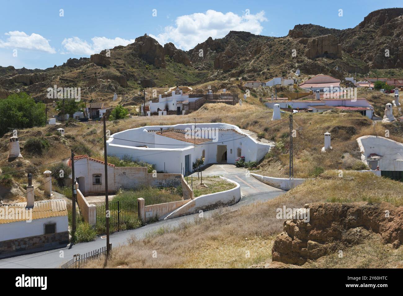 Blick auf das sonnige Dorf mit weißen Häusern und felsiger Landschaft im Sommer, Höhlenwohnungen, Höhlenviertel, Troglodytos, Barrio de Cuevas, Guadix, Granada Prov Stockfoto