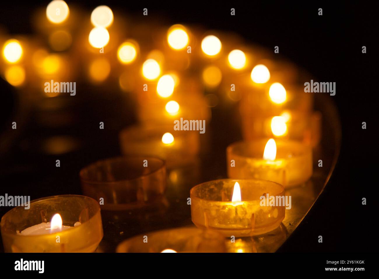 Votive-Teelicht-Kerzen hintereinander Stockfoto