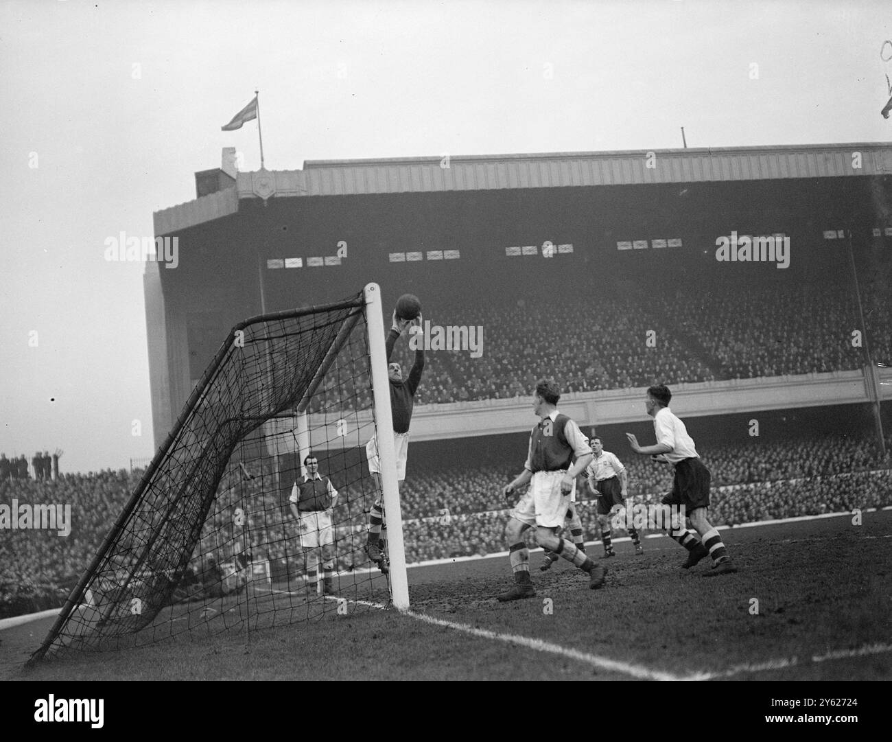 Swindin, Torhüter von Arsenal, erspart heute beim Arsenal-Preston-Spiel in Highbury einen hohen Schuss vor Prestons Macintosh (rechts). Dabei ist Arsenal rechts-halb McAulay (vorne), während Barnes das Arsenal links-hinten (ganz links) das Tor im Notfall bewacht. 31. Januar 1948 Stockfoto