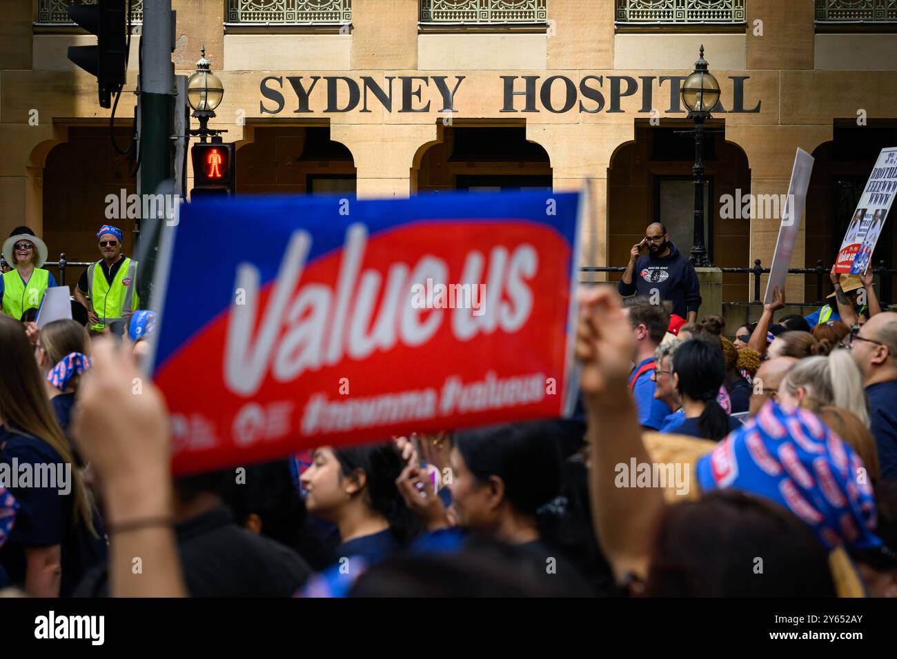 Sydney, Australien. September 2024. Ein Demonstrant hält während der Kundgebung vor dem Sydney Hospital ein Plakat mit der Aufschrift „Value US“. Krankenschwestern und Hebammen in ganz New South Wales streikten 24 Stunden und marschierten vom Hyde Park durch Sydneys Straßen zum Parlament in New South Wales und forderten eine bessere Gehaltserhöhung. Der Verband fordert eine Lohnerhöhung von 15 %, während die Regierung nur 3 % angeboten hat. (Foto: George Chan/SOPA Images/SIPA USA) Credit: SIPA USA/Alamy Live News Stockfoto