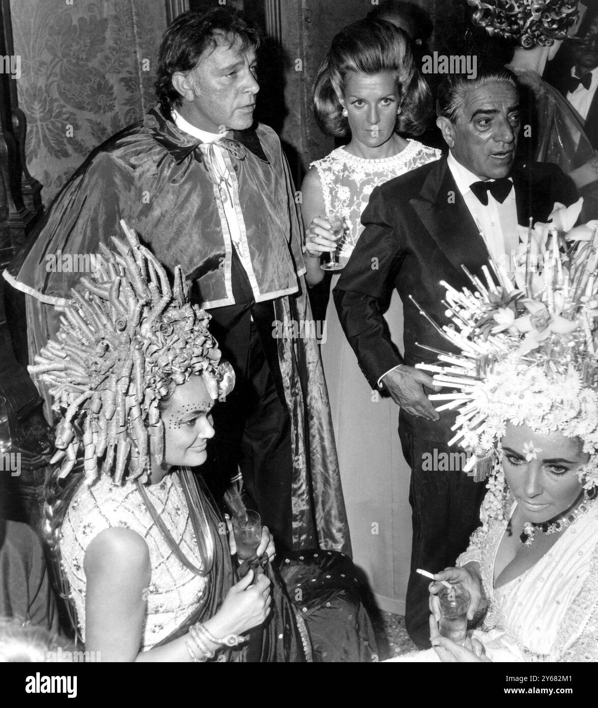 Am 9. September 1967 wurde Richard Burton (links stehend mit cape) Elizabeth Taylor (vorne rechts), Gräfin Marina Cicogna (stehend) und Aristoteles Onassis gesehen. Die Dame vorne links ist unbekannt. Stockfoto