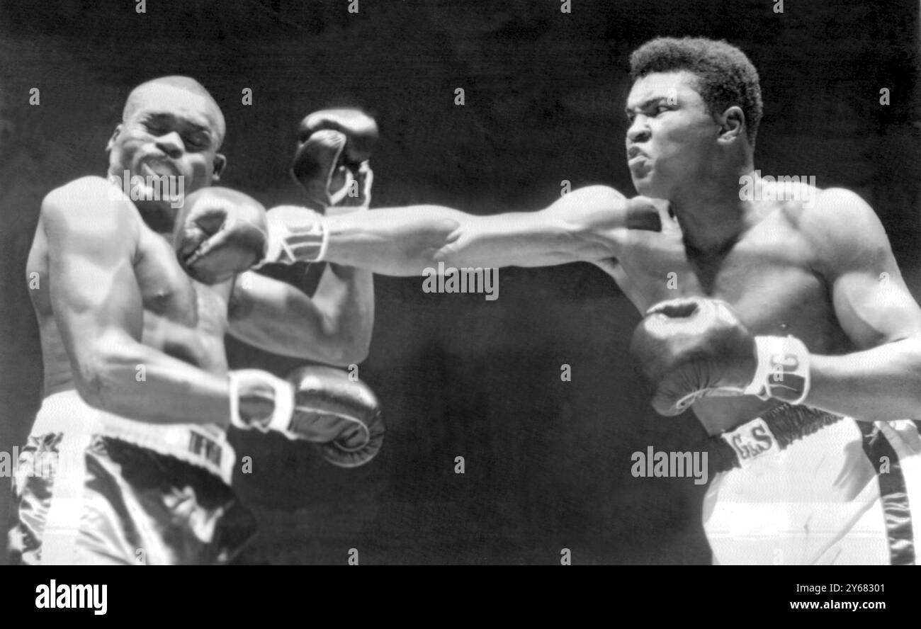 Cassius Clay (rechts), das 21-jährige ungeschlagene US-Schwergewicht, verbindet sich in der ersten Runde des 10-Runden-Wettbewerbs im Madison Square Garden mit einem Recht auf den Kiefer von Doug Jones. Clay konnte Jones in der vierten Runde nicht, wie er vorhergesagt hatte, schlagen, tat aber genug, um eine Punkteentscheidung zu erzielen. Es war jedoch ein unbeliebter Sieg mit den meisten der 18.000 Fans, da sie Clay für mehr als fünf Minuten nach dem Urteil buchten. März 1963. Stockfoto