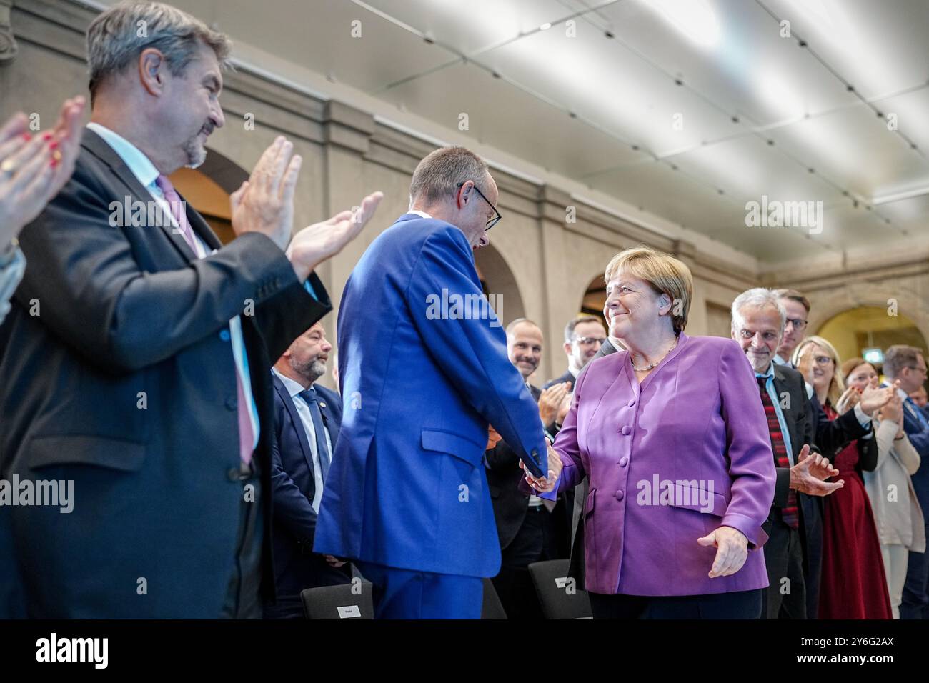 Berlin, Deutschland. September 2024. Angela Merkel und Friedrich Merz (M), Bundesvorsitzender der CDU und Vorsitzender der CDU/CSU-Fraktion, schütteln bei der Berliner Sonderdiskussion anlässlich des 70. Geburtstages des ehemaligen Bundeskanzlers die Hand neben Markus Söder (l), Ministerpräsident von Bayern und Vorsitzender der CSU. Quelle: Kay Nietfeld/dpa/Alamy Live News Stockfoto