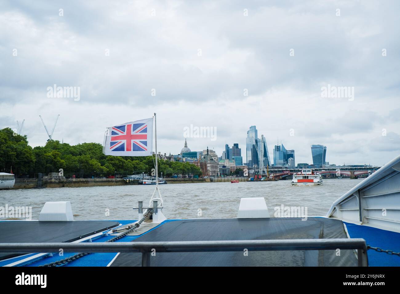 Bootsfahrt auf der Themse in Richtung Southwark Bridge. Die britische Flagge winkt. Flagge des Vereinigten Königreichs im Wind. Sehenswürdigkeiten in London. Weiterreisen Stockfoto