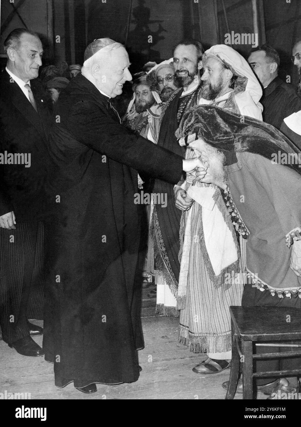 Noch in Kostümen küssen Schauspieler aus dem Passionsspiel die Hand des päpstlichen Legaten Gustavo Kardinal Testa , der nach dem Besuch des Passionsspiels hinter die Bühne geht . Der Kardinal war in Deutschland als Vertreter von Papst Johannes auf dem 37. Eucharistischen Weltkongress in München tätig. Links sieht der Regisseur Johannes Georg lang. 3. August 1960 Stockfoto