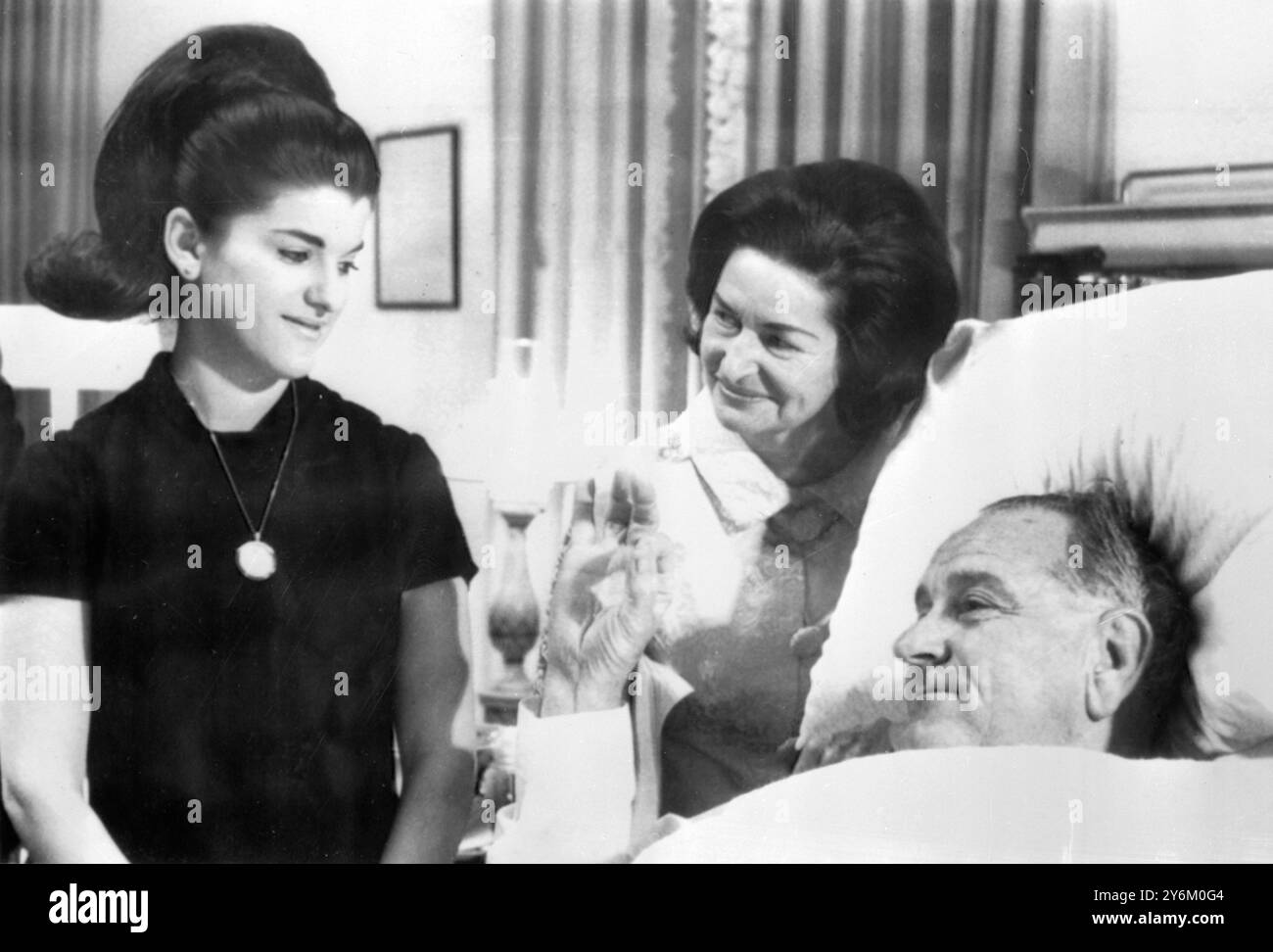 Bethesda Naval Hospital, Washington: Der US-Präsident Lyndon B. Johnson gibt dieser Frau Claudia 'Lady Bird' Johnson (Zentrum) und Tochter Luci Baines Johnson das 'O.K.'-Zeichen, nachdem er am heutigen 16. November erfolgreich operiert wurde, um einen nicht krebsartigen Polyp im Hals zu entfernen und eine Bauchhernie zu korrigieren. Es wird erwartet, dass der 58-jährige Präsident in nächster Zukunft aus dem Bett gehen und gehen darf. 16. November 1966 Stockfoto