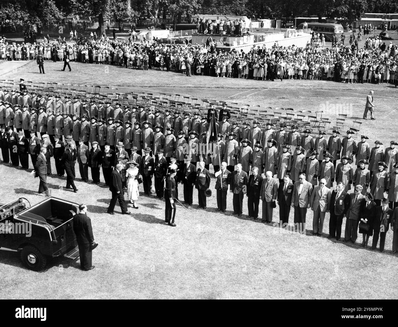 Königin Elizabeth II. In blauem Sommerkleid und breiter Krempe, gefolgt von dem Duke of Edinburgh, der seine Befehle und Medaillen auf seinem dunklen Loungeanzug trug und das blinde Kontingent bei den Grand Hyde Park Coronation Reviews inspizierte. - Rund 72 000 ehemalige Soldaten und Frauen nehmen an der Parade am 5. Juli 1953 Teil Stockfoto