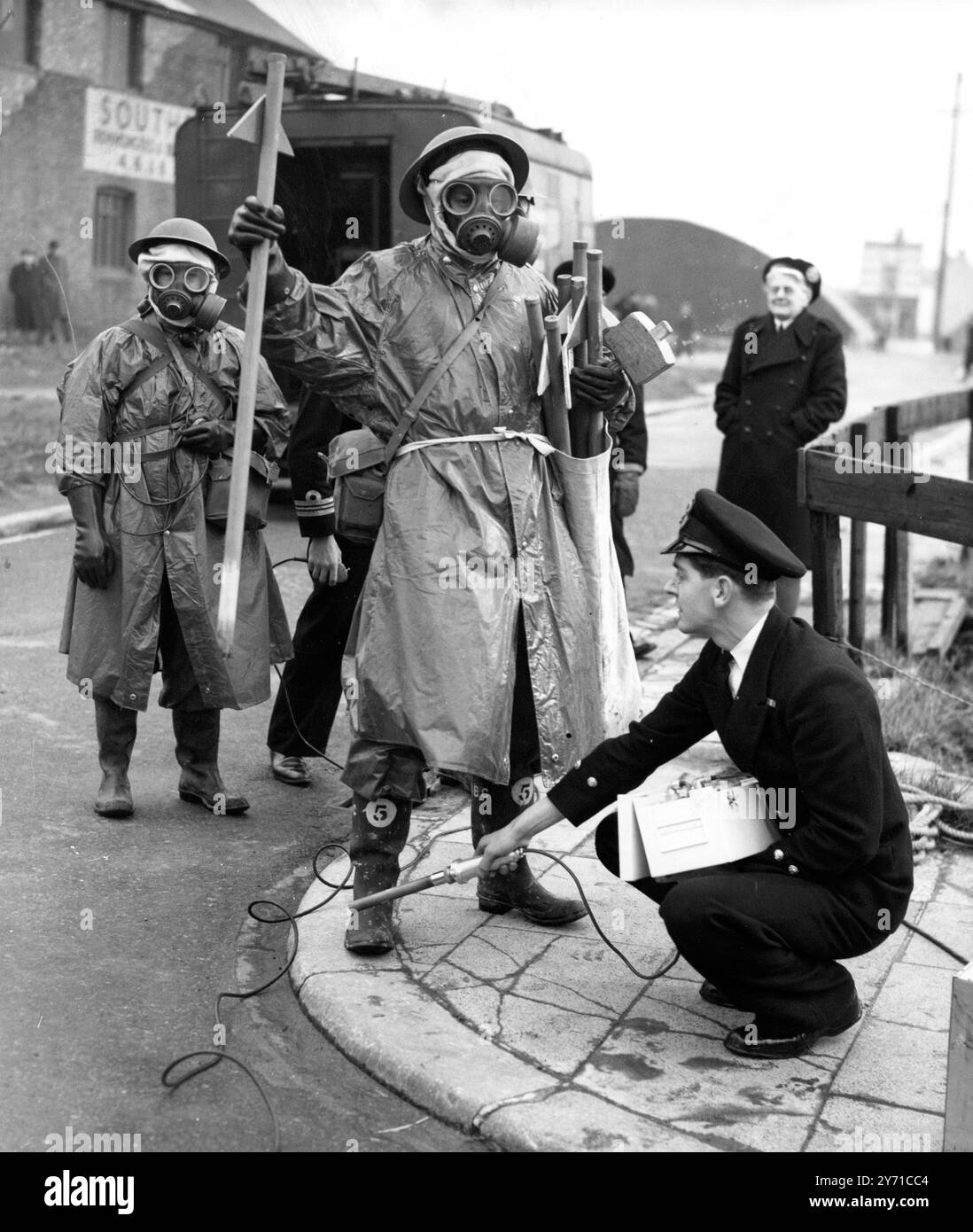 Das Radio Activity Monitoring Team der HMS Phoenix kehrt von einem " Recce " mit geigerzählern in einem Bombengebiet von Southsea , Portsmouth , zurück und wird von einem Kontaminationszähler überfahren , der hier vom Chief Petty Officer E Stannard aus Portsmouth gehalten wird . Sie nahmen an einer zivilen Verteidigungsübung in Mazedonien in der Stadt Teil und arbeiteten mit 1500 Soldaten aus der Region Aldershot und lokalen zivilen Verteidigungseinheiten zusammen . Als er auf Radioaktivität überprüft wird, ist Chief Petty Officer CW Brooks aus Portsmouth zu sehen. 25. Februar 1951 Stockfoto