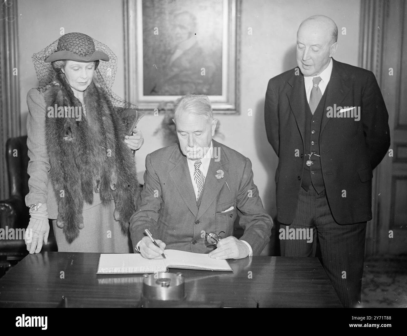 Colonel McCormick in Edinburgh. Colonel Robert Rutherford McCormick signiert das Visitor's Book in den City Chambers in Edinburgh. Mrs. McCormick sieht mit Mr. Bailie T Scott, dem Chefmagistrat von Edinburgh. Juli 1948 Stockfoto