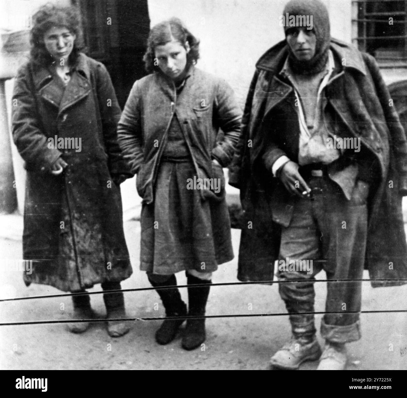 158 Gefangene Guerillas marschierten durch die Straßen von Salonica , auf denen sich fast die gesamte Stadtbevölkerung versammelt hatte, um die erbeuteten Überreste der fünfhundertachtzig Mann starken Bande zu bohren , die drei Nächte zuvor das Feuer eröffnet und die Stadt beschossen hatte . Nach drei Tagen Kämpfen war die Band fast vollständig ausgerottet . 164 Leichen wurden aus Schluchten , Berghängen und Wäldern gesammelt , durch die die Band verzweifelt versucht hatte zu fliehen . Unter den Gefangenen waren eine Reihe hochrangiger Guerillachefs und neun Frauen . Hier sehen wir ein paar der verwundeten Guerillas, die Shor gesehen haben Stockfoto