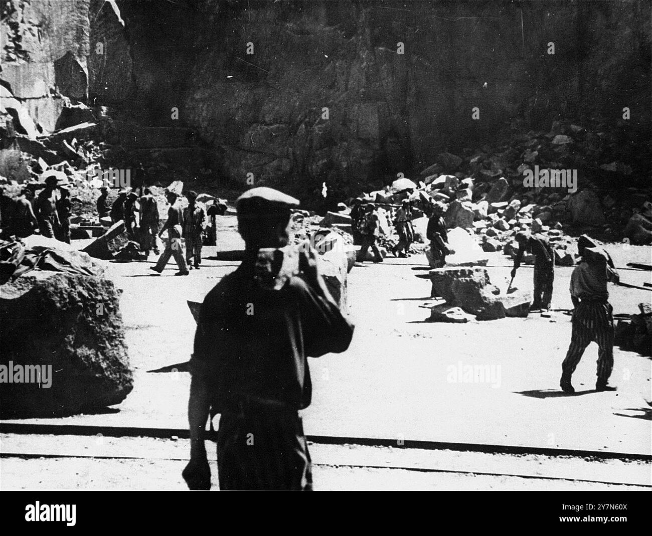 Zwangsarbeitsgefangene im Wiener Graben-Steinbruch im KZ Mauthausen. Mauthausen war ein NS-Zwangsarbeitslager, das Teil des Mauthausen-Komplexes war. Auf seiner Höhe hatte sie 85.000 Gefangene auf einmal. Es war berüchtigt für seine Härte - es wird geschätzt, dass von den 190.000 Gefangenen, die während der Operationen dort festgehalten wurden, die Hälfte vollständig gestorben ist. Dort befand sich der Wiener Graben und seine gefürchteten Todessteige, wo viele starben, als sie riesige Lasten die 186 Steintreppen hinauftrugen. Stockfoto