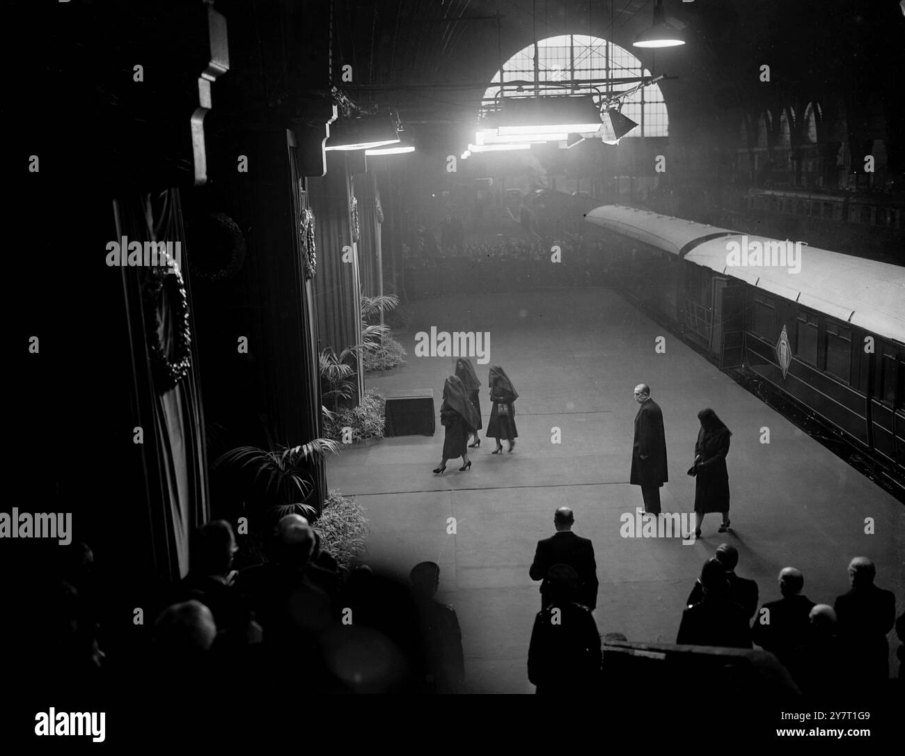 Der Sarg von König Georg VI. Kommt in London an. Die beiden Königinnen und Prinzessin folgen dem Zug aus der Station. Fotoshows: Die neue Königin, Elizabeth II., die Königin Mutter und Prinzessin Margaret, verlassen den Bahnsteig am Bahnhof King's Cross. London , nach dem Sarg, der gerade aus dem Bahnhof für die Beerdigungsprozession durch London zur Westminster Hall am 11. Februar 1952 gebracht worden war Stockfoto