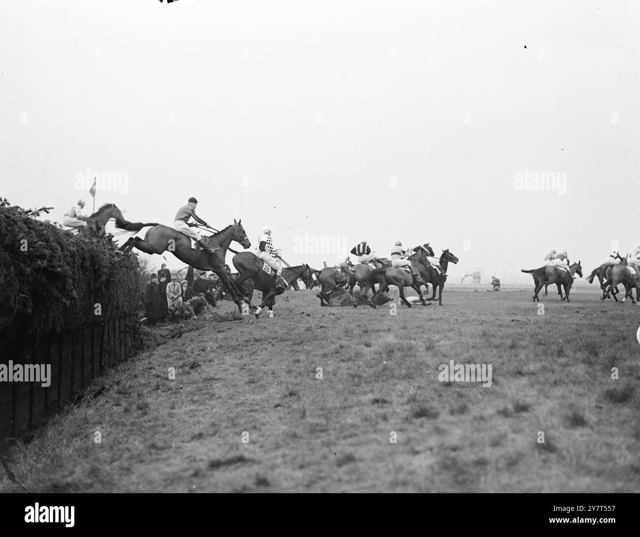 ROIMOND, KÖNIGLICHER LEITER, ABER RUSSISCHER HELD GEWINNT Russian Hero , im Besitz von Mr . W.F. Williamson und geritten von Leo McMorrow, 27-jähriger Ire aus Mountshannon ( Co. Slingo ) gewann den Grand National Steeplechase in Aintree, Liverpool . Er beendete acht Längen vor Lord Bisectors Roimond 9 R. Francis oben ) . Royal Mount , im Besitz von Mrs . M. Hervey und Ritten von P. Doyle war Dritter . DAS BILD ZEIGT ;-WOT NO SUN ( Nr 32 ) , geritten von G . KELLY, kommt ein Sturz, als das Feld Bechers Brook zum 2. Mal nimmt . 26. März 1949 Stockfoto