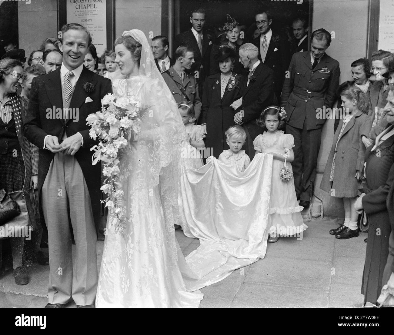 LUCAS DSO, DFC und Bar, HEIRATETE IN der Grosvenor Chapel, South Audley Street, LONDON, Miss Jill Doreen Addison, Tochter von Oberstleutnant und Frau AM Addison aus Ascot. Die Schwester der Braut ist mit dem anderen berühmten Piloten der britischen Schlacht verheiratet, dem Gruppenkapitän Douglas Bader, DSO amd Bar, DFC und Bar, der ein fester Freund von Lucas ist. Foto-Shwos: Die kleinen Brautwächter, die den Zug der Braut hochhalten, während Braut und Bräutigam die Grosvenor Chapel in London nach der Zeremonie verlassen. 22. Mai 1946 Stockfoto