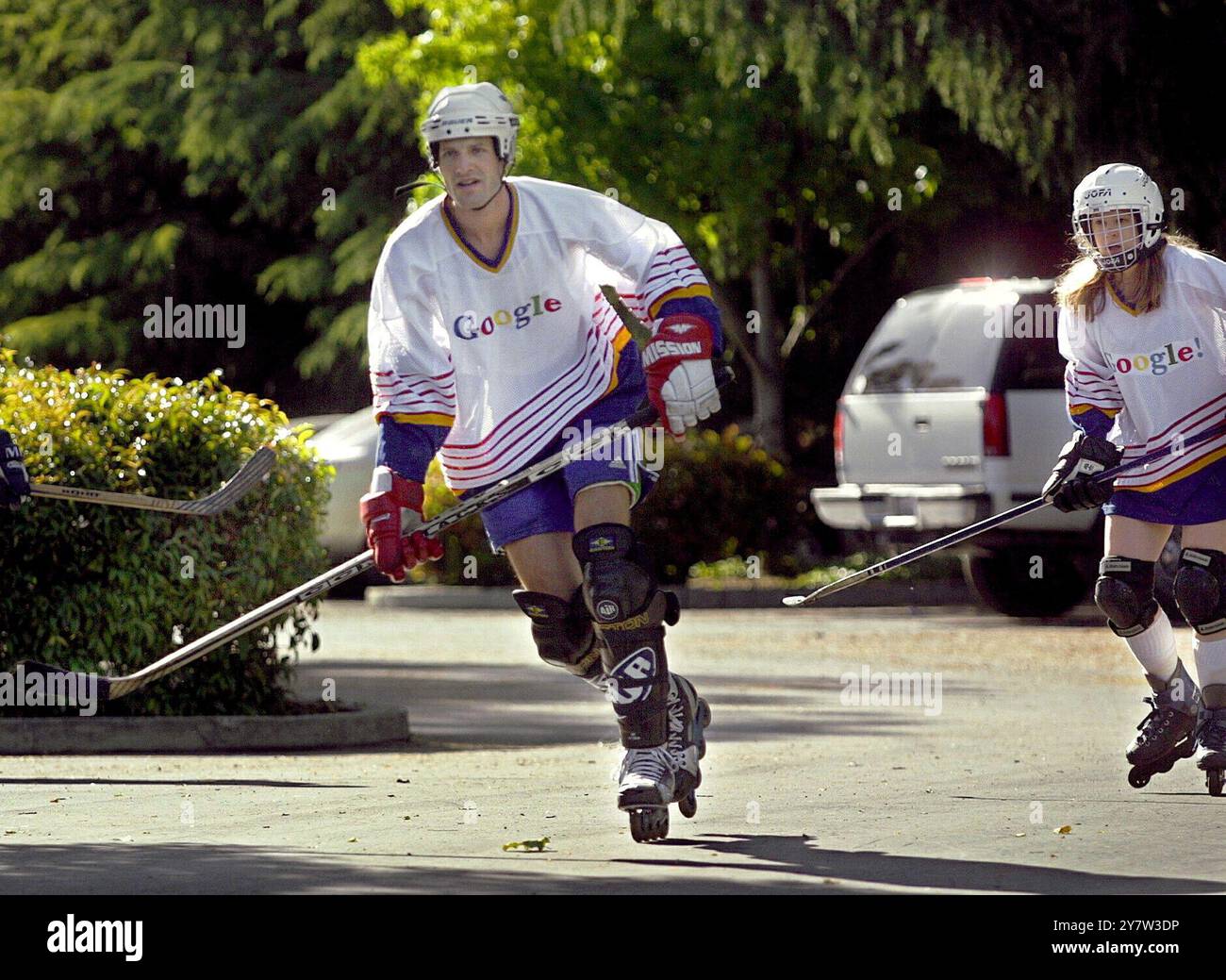 Mountain View, Kalifornien: Ein Systemadministrator und Asoftware-Ingenieur mit Google spielt Rollhockey auf dem Firmenparkplatz. Google fördert einen gesünderen Lebensstil, indem er wöchentliche Hockeyspiele veranstaltet und gesündere Speisen in der Cafeteria des Unternehmens serviert. Mai 2001. Stockfoto