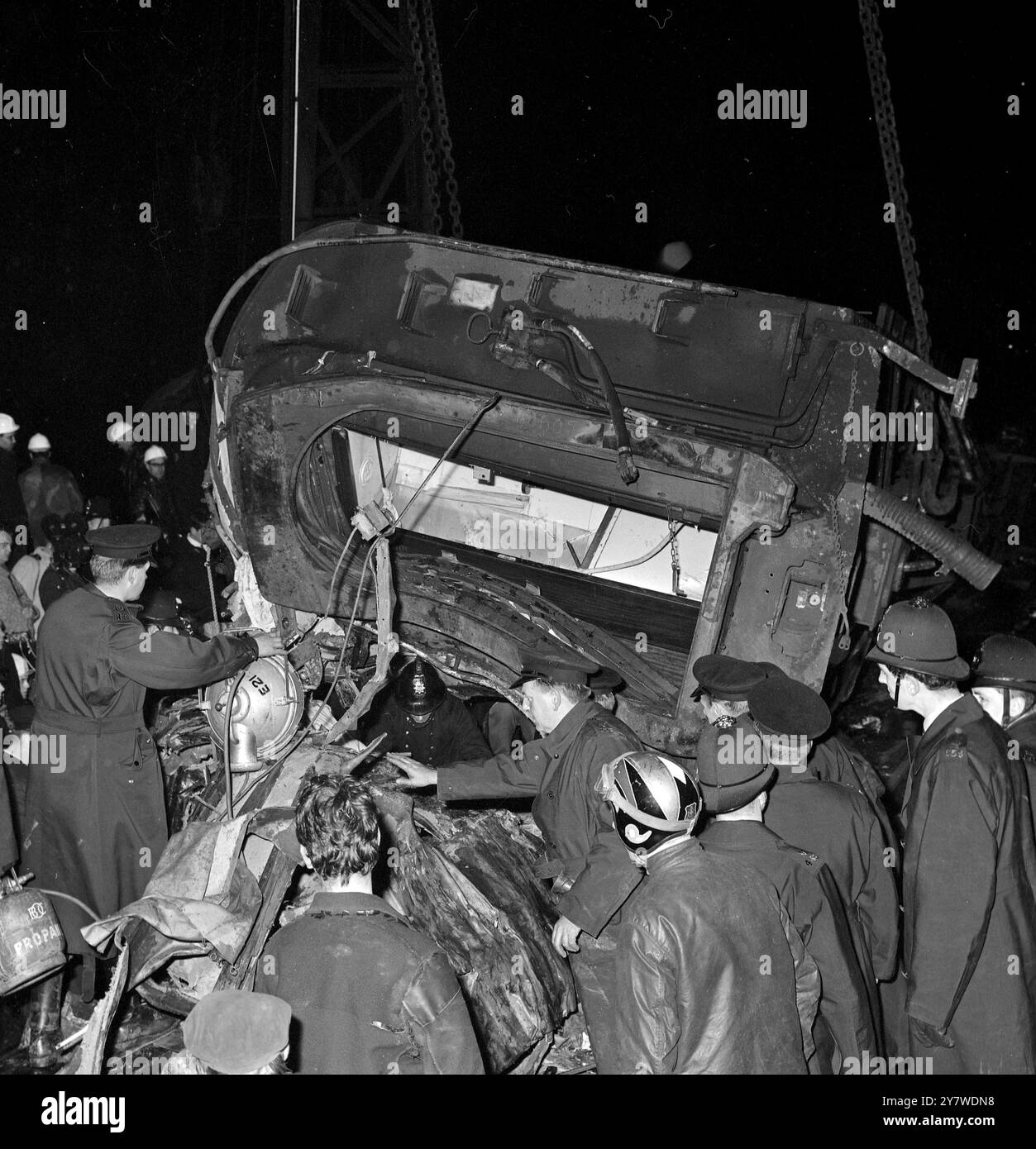 Alle Augen konzentrieren sich auf die Lücke, aus der der Feuerwehrmann auftaucht Die Rettungsaktion findet statt, unter den Trümmern des Hastings-Charing Cross-Zugunglücks. Der Zug übersprang die Linien in Hither Green, während er mit über 50 km/h fuhr. Nach den jüngsten Zahlen wurden 51 Menschen getötet und 139 verletzt . November 1967 Stockfoto