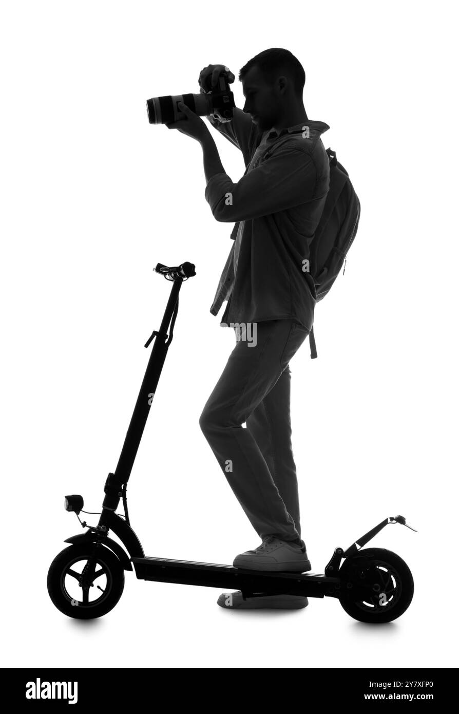 Silhouette eines männlichen Fotografen mit Kamera und Elektroroller auf weißem Hintergrund Stockfoto