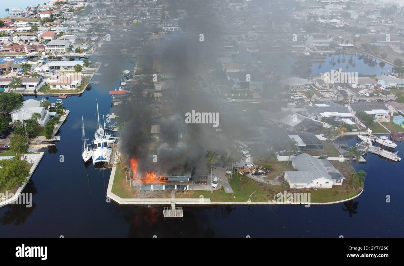 Hudson, FL, 1. Oktober 2024 -- wie um die Verletzung noch weiter zu belasten, fing ein Haus in der Sea Ranch Gegend von Hudson, FL in Brand, nachdem die meisten Häuser hier letzte Woche mehrere Meter Wasser vom Hurrikan Helene eingenommen haben. Foto von Liz Roll Stockfoto
