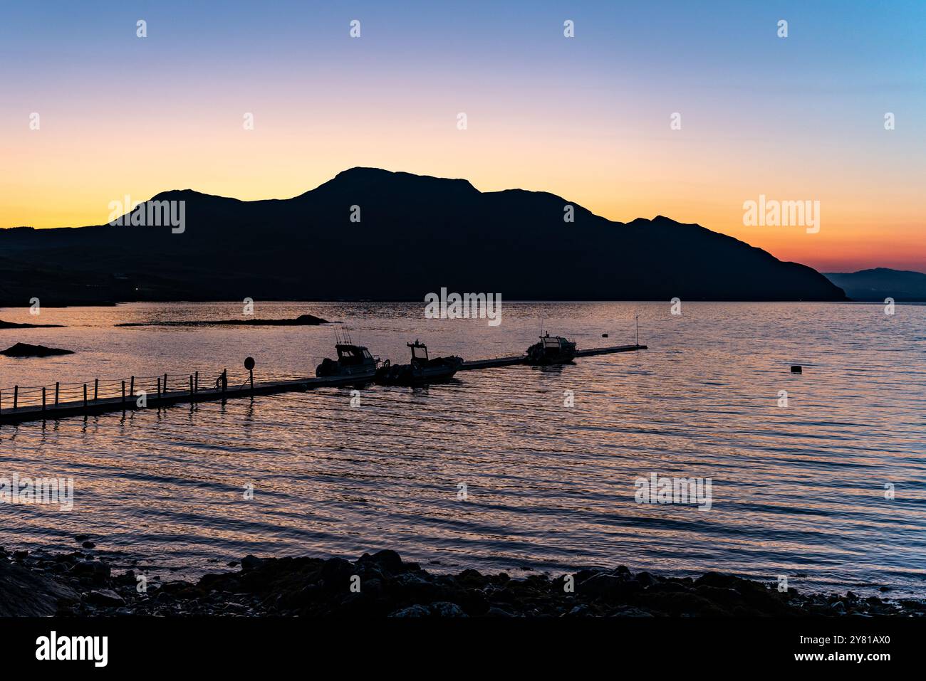 Sonnenaufgang über Ben Hiant mit Booten im Vordergrund, Kilchoan, Ardnamurchan Stockfoto