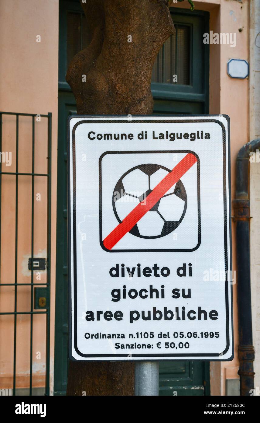Kommunales Verbotsschild, das das Fußballspiel auf einem Baumstamm in der Altstadt von Laigueglia (Savona), Ligurien, Italien verbietet Stockfoto