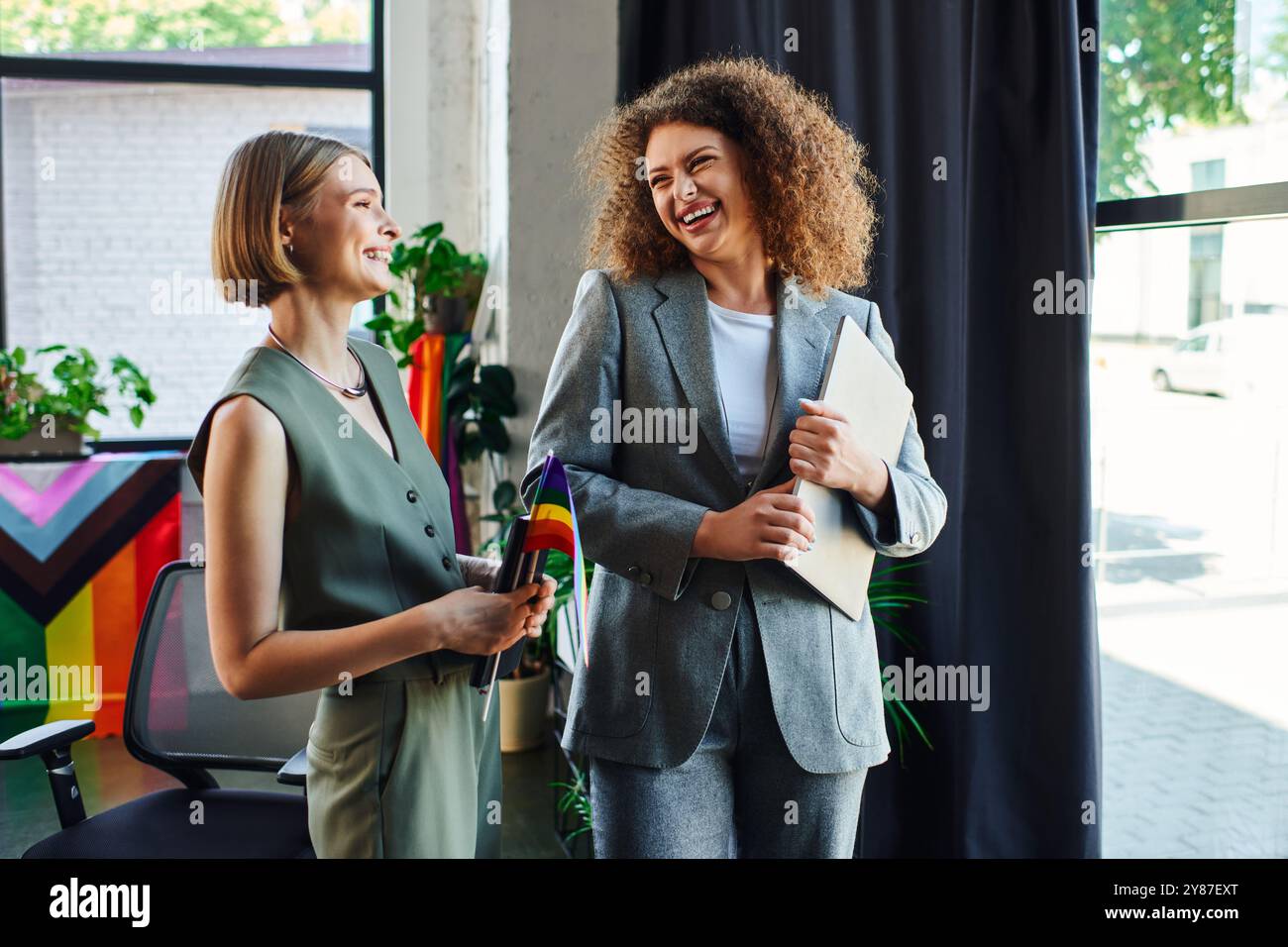 Zwei Kollegen teilen einen freudigen Moment und fördern Inklusivität in ihrem Arbeitsbereich. Stockfoto