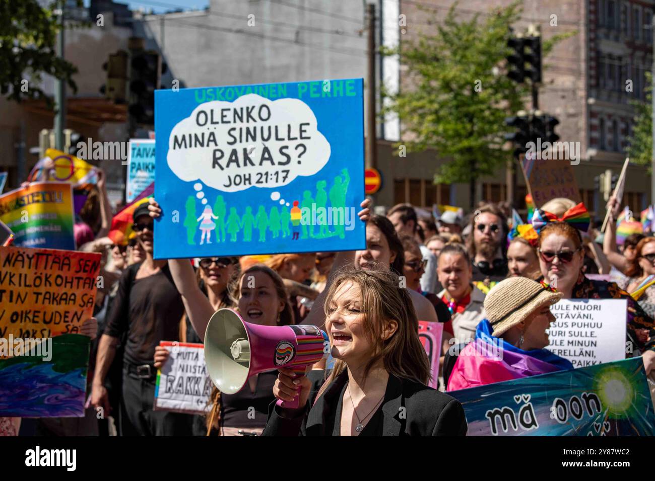 Chorleiter mit Megaphon, der die Opfer der Religion bei der Helsinki Pride 2024 Parade auf der Mannerheimintie in Helsinki, Finnland, führt Stockfoto