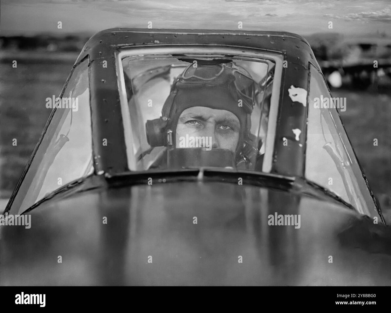 Der fliegende Offizier Frank Murphy von 486 Squadron im Cockpit eines Hawker Typhoons, eines britischen einsitzigen Jagdbombers, der als Ersatz für den Hawker Hurricane in mittlerer Höhe vorgesehen war. Doch als die Luftwaffe 1941 die neue Focke-Wulf FW 190 in Dienst stellte, war der Taifun der einzige RAF-Jäger, der sie in niedrigen Höhen fangen konnte, wodurch er eine neue Rolle als Abfangjäger in niedriger Höhe erhielt. Es wurde zu einem nächtlichen Eindringling und Langstreckenjäger und wurde mit verstärkten Waffen zu einem der erfolgreichsten Bodenangriffsflugzeuge des Zweiten Weltkriegs. Stockfoto