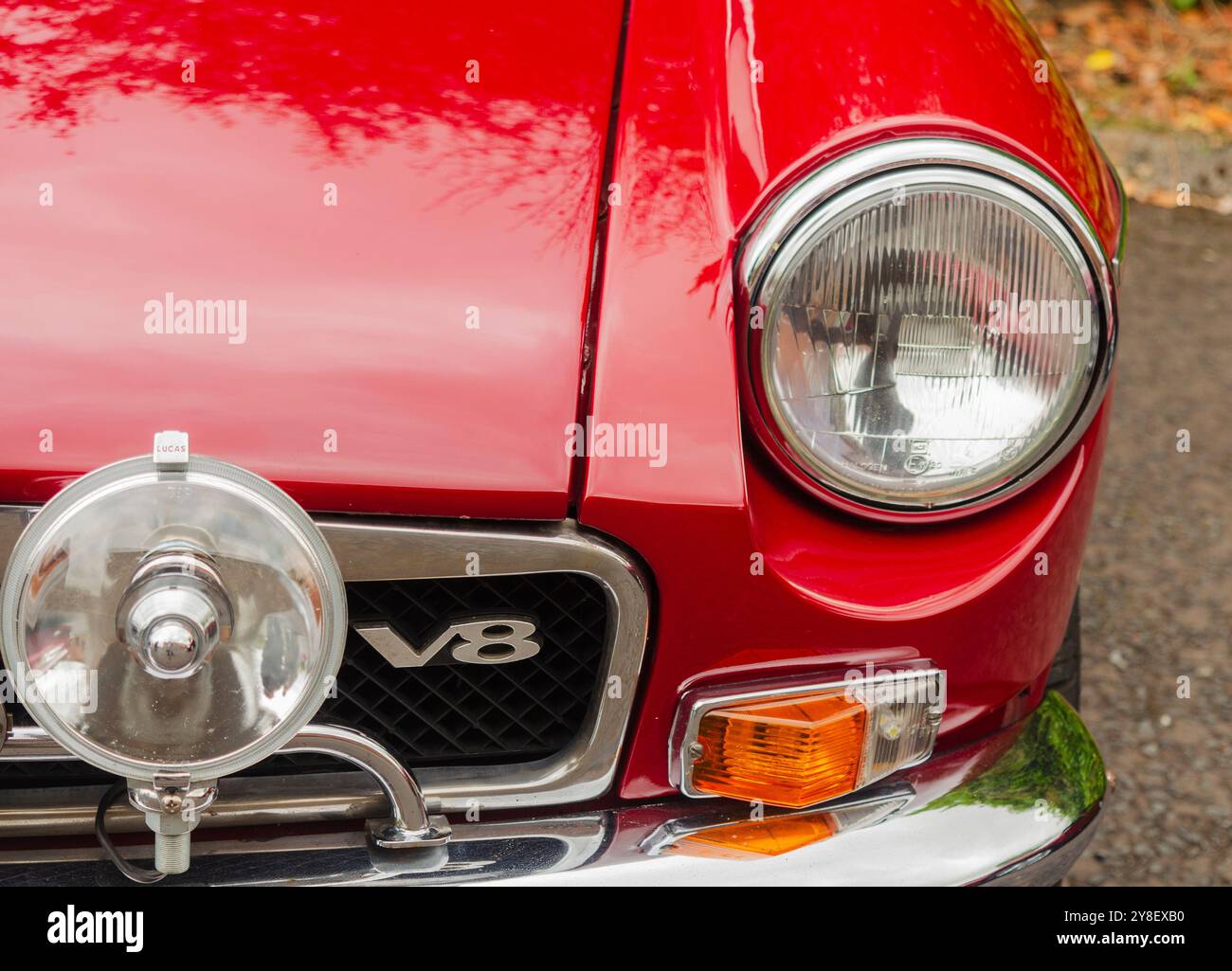 Carryduff County Down Nordirland 21. September 2024 – Nahaufnahme eines MG-Oldtimers mit Chrom-Stoßfänger und Frontscheinwerfer und V8-Aufkleber Stockfoto