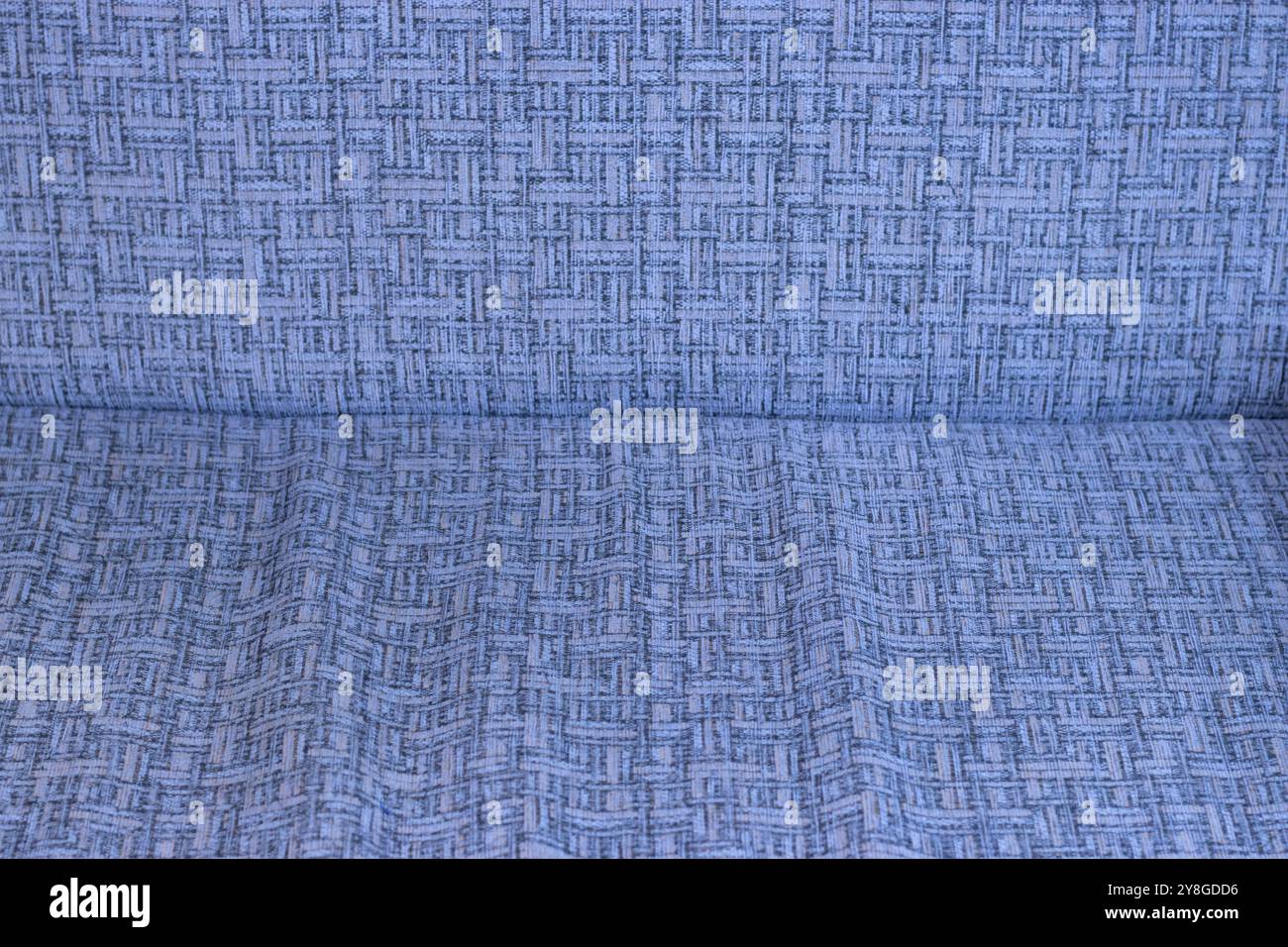 Dieses Bild zeigt eine Nahaufnahme eines Stoffes mit einem detaillierten geometrischen Muster. Stockfoto