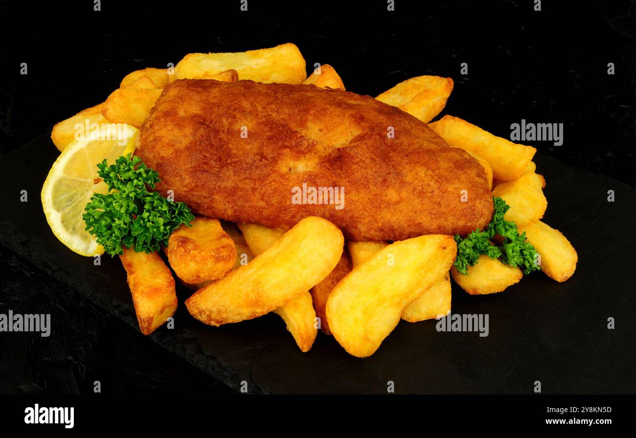 Kabeljaufilet in Bier mit groben Pommes frites und Zitronengarnitur Stockfoto