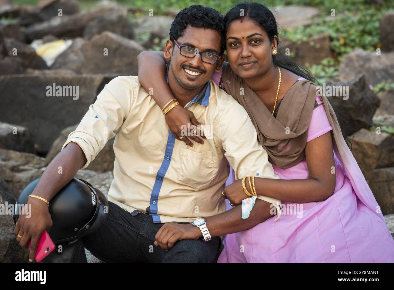 Frau umarmt Mann mit Handy, junges verheiratetes indisches Paar, Fort Cochin, Kochi, Kerala, Südindien, Indien, Asien Stockfoto