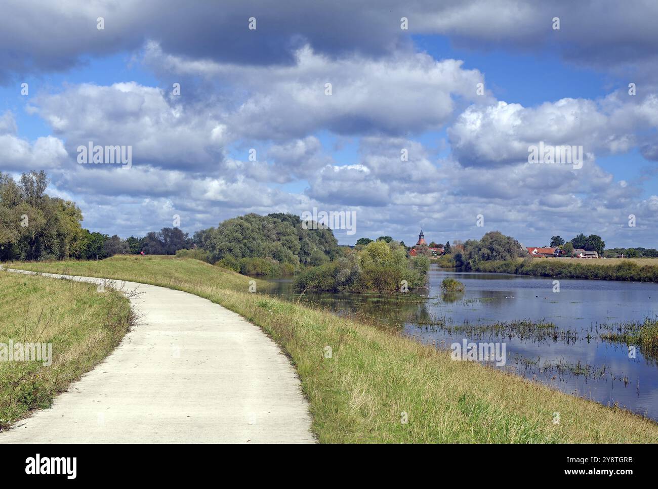 Ein schmaler Weg entlang eines Flusses mit Blick auf mehrere Häuser und Bäume, Schnackenburg die kleinste Stadt Deutschlands, Elbe, Wendland, Niedersachsen, Deutschland Stockfoto