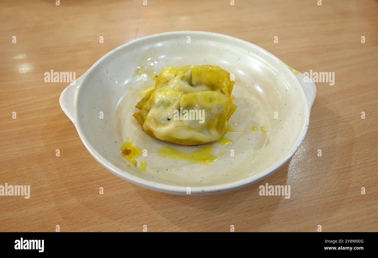 Zwei frisch gebratene Teigtaschen auf dem weißen Teller, bereit zum Essen Stockfoto