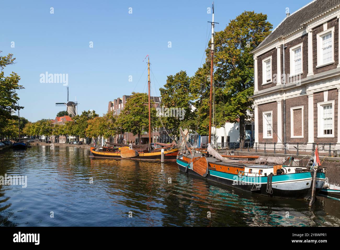 Alter Hafen im Zentrum von Schiedam mit einer Mühle im Hintergrund. Stockfoto