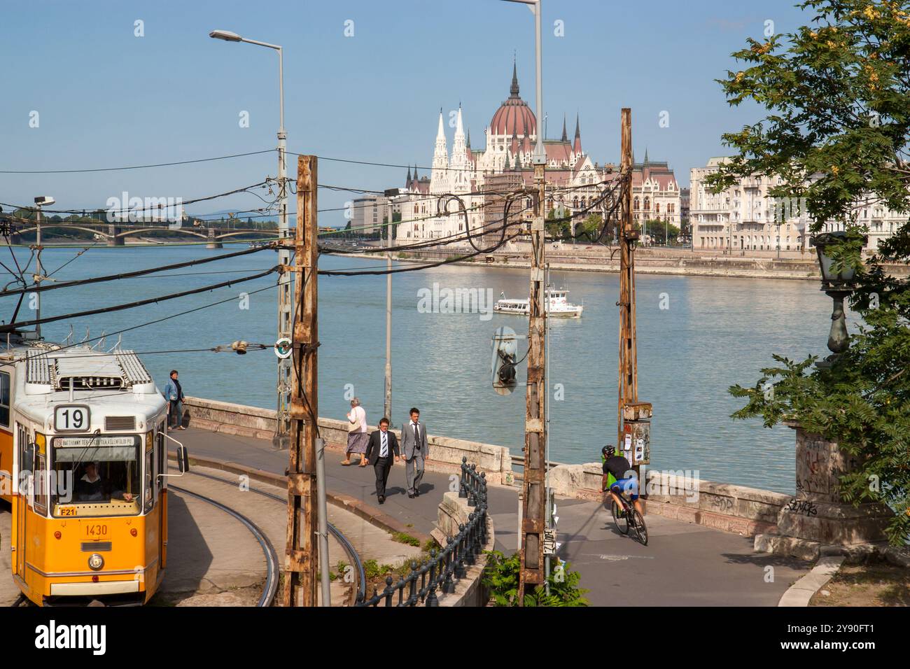 Boedapest, Ungarn 13. september 2008. Städtisches Aussehen des ungarischen Parlamentsgebäudes mit Menschen, einer gelben Straßenbahn und der Donau mit Boot Stockfoto