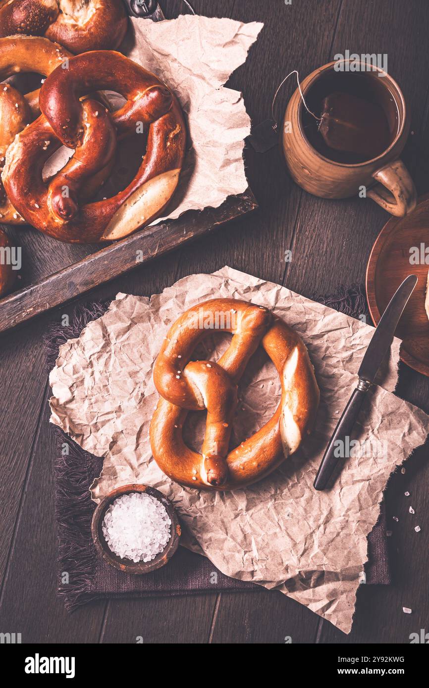 Deutsche Brezeln auf Küchentisch mit Salz und Butter Stockfoto