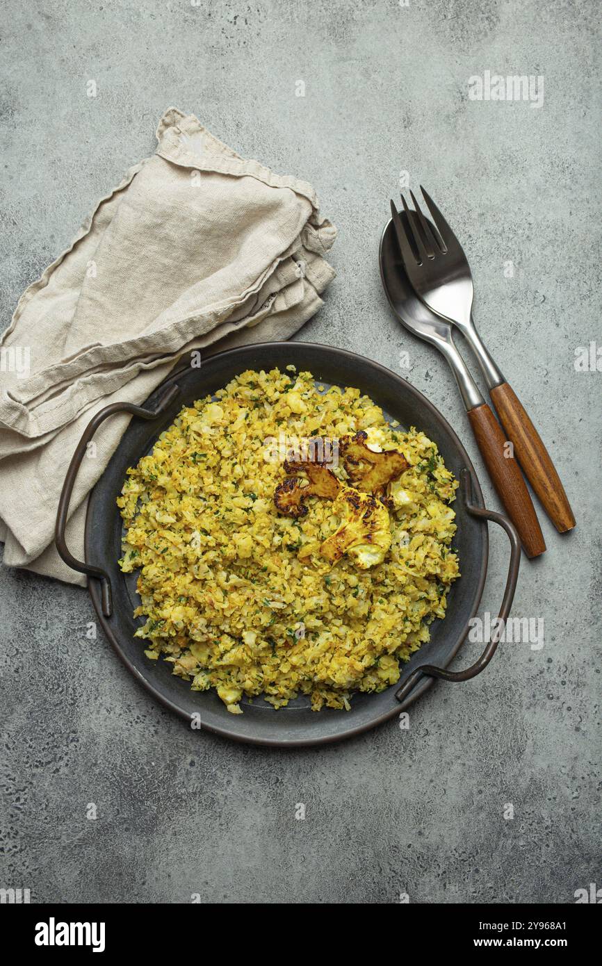 Gebratener Blumenkohl-Reis oder Couscous mit Dill auf dem Teller, gesunde kohlenhydratarme Gemüse-Beilage für Keto-Diät und gesunde kalorienarme Ernährung Stockfoto