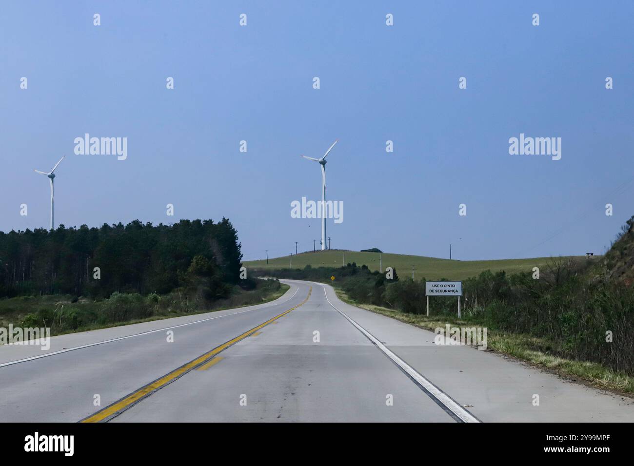 Windkraftanlage an einem wolkenlosen blauen Himmel. Das System zur Erfassung von Energie aus dem Wind, genannt Windkraft, verwendet Fangtürme mit drei Propellern Stockfoto