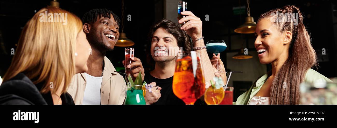 Kollegen genießen ein lebhaftes Firmentreffen, bei dem sie gemeinsam bunte Cocktails zaubern. Stockfoto