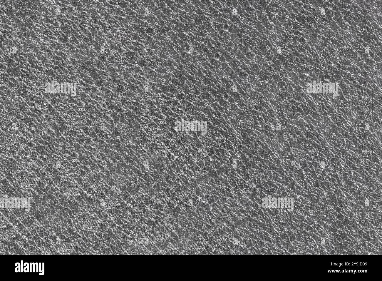 Abstrakte Metallic-Garne verflechten sich zu einem schimmernden Hintergrundeffekt, der kompliziertes Design und Textur in einer fesselnden visuellen Darstellung präsentiert Stockfoto