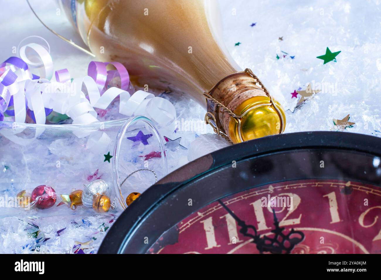 Silvesterfeier Stillleben mit Champagnerflasche, Konfetti und Uhr Stockfoto