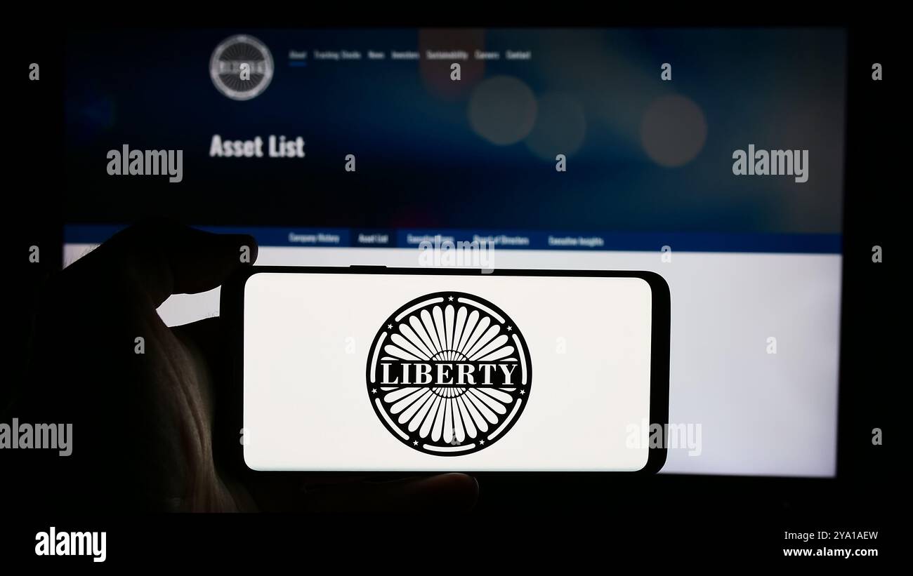 Deutschland. August 2024. In dieser Abbildung hält eine Person ein Handy mit dem Logo des US-amerikanischen Medienunternehmens Liberty Media Corporation vor der Unternehmenswebsite. (Foto von Timon Schneider/SOPA Images/SIPA USA) *** ausschließlich für redaktionelle Nachrichten *** Credit: SIPA USA/Alamy Live News Stockfoto