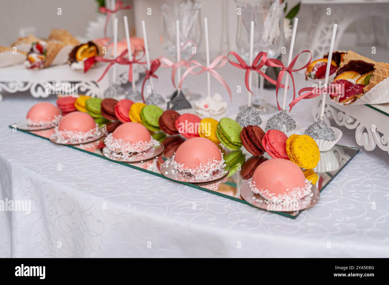 Exquisite Dessertpräsentation mit delikaten Backwaren und bunten Makronen. Stockfoto
