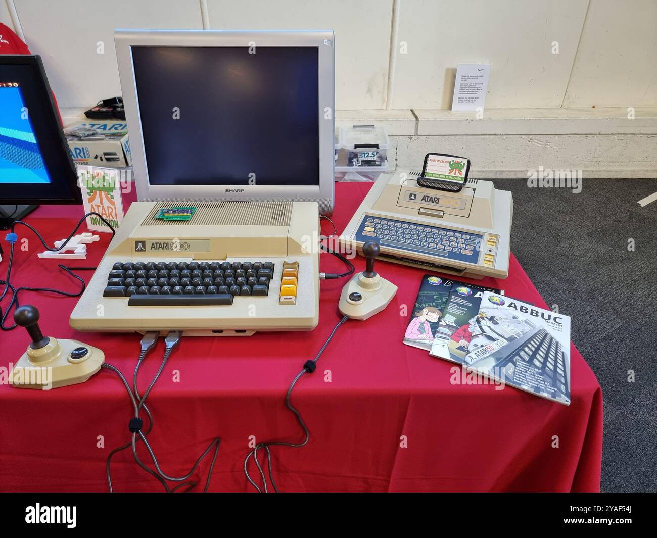 Alte, historische Atari-Computer mit Monitoren auf einem roten Tisch im HCC Kennisdag in der Expo Houten, Niederlande Stockfoto